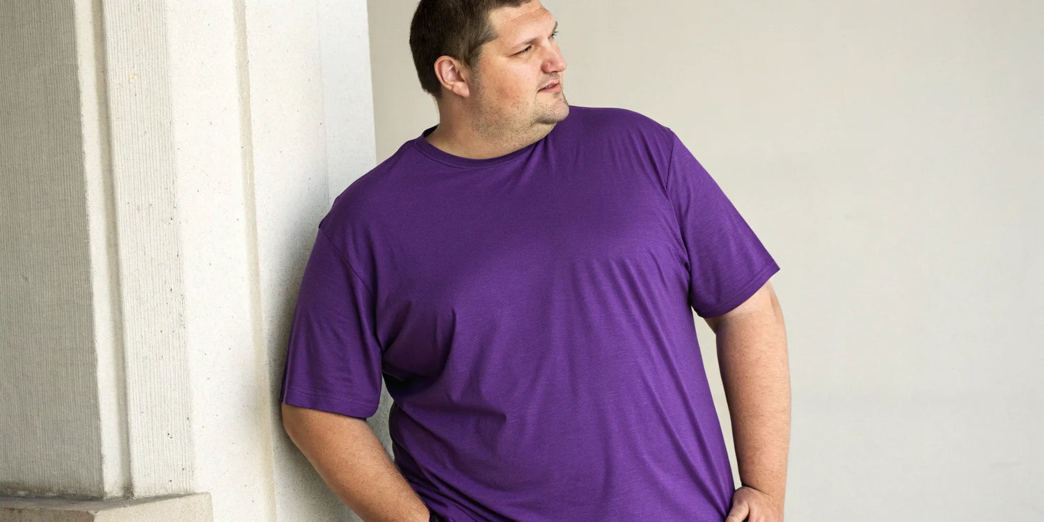 Big and tall man wearing a well-fitting purple t-shirt.