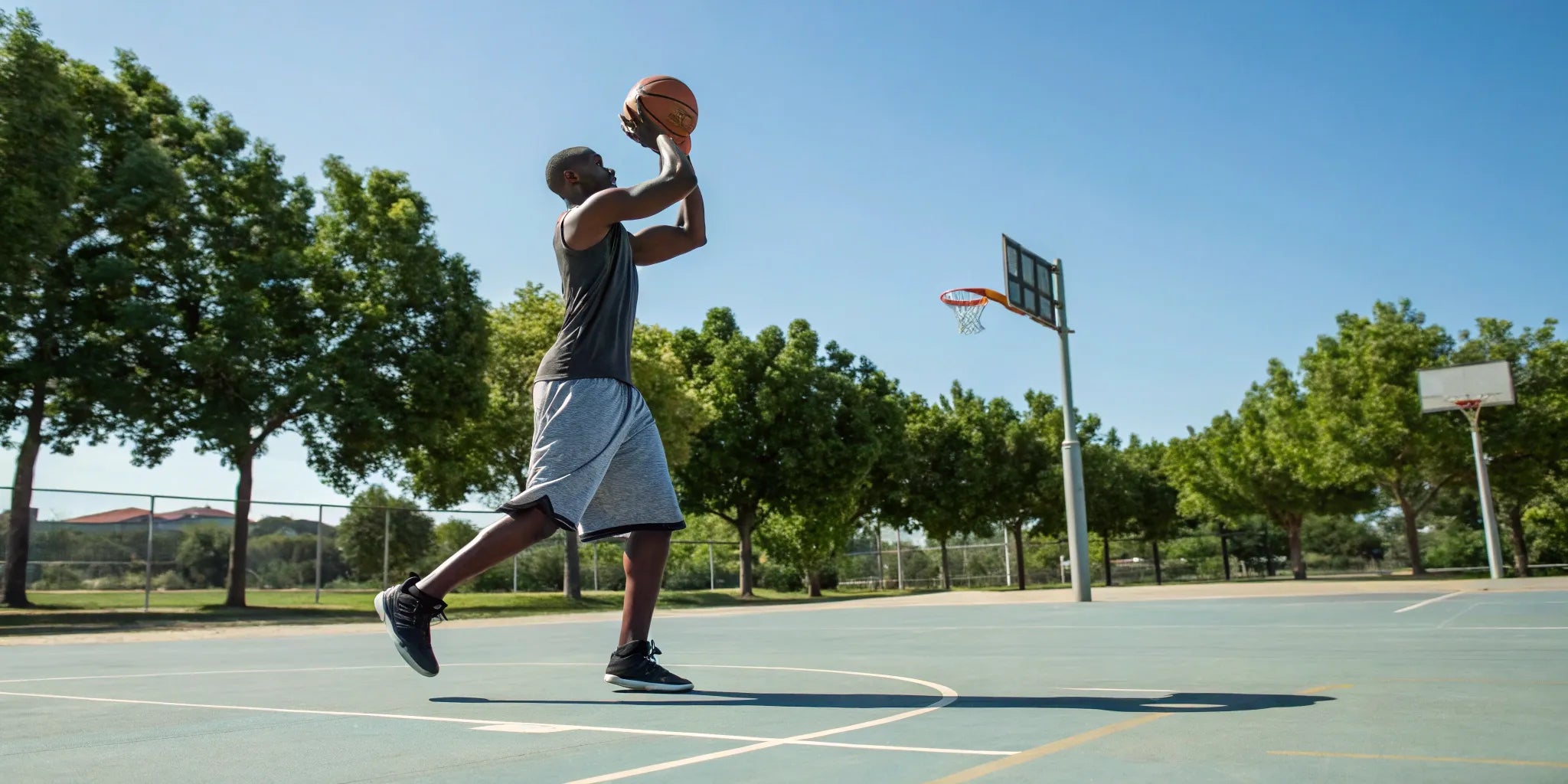 A big and tall man wearing comfortable basketball shorts.