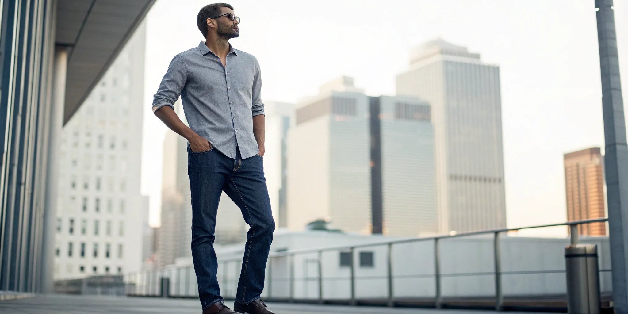 A big man confidently wearing affordable clothes, including a casual button-down shirt and jeans.