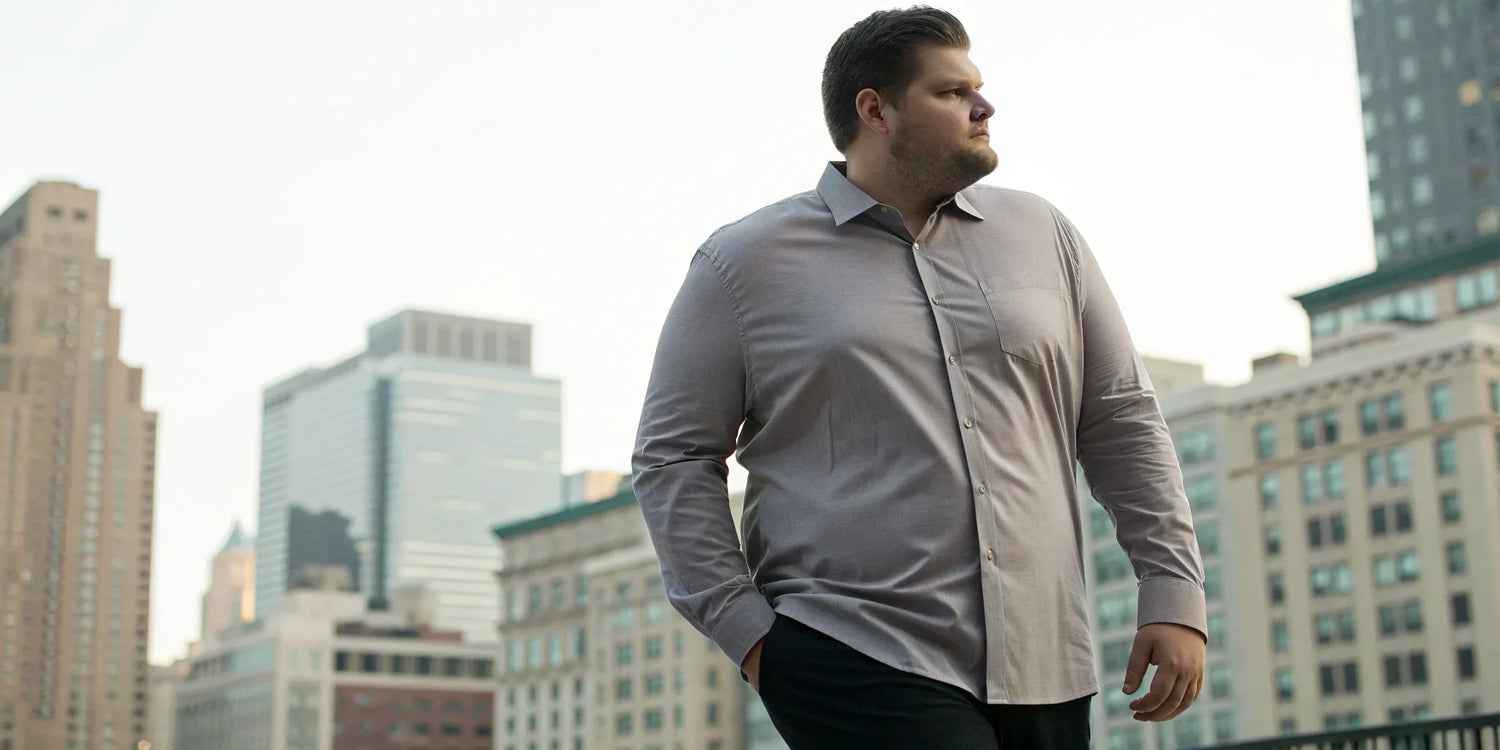 A big and tall man wearing a stylish, well-fitting long sleeve mens shirt.