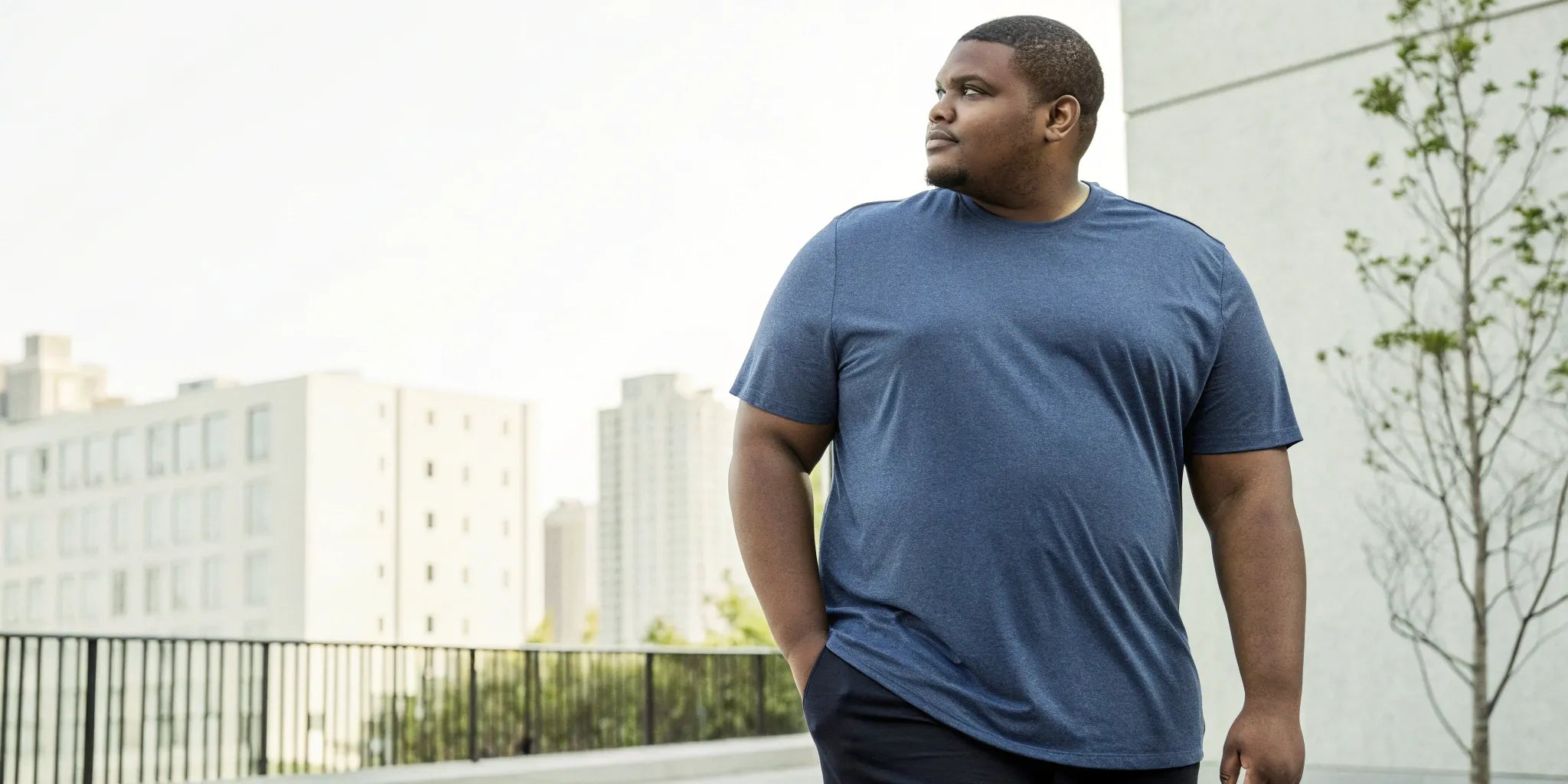 Man wearing one of the best t-shirts for a big belly, with a flattering fit and proper length.