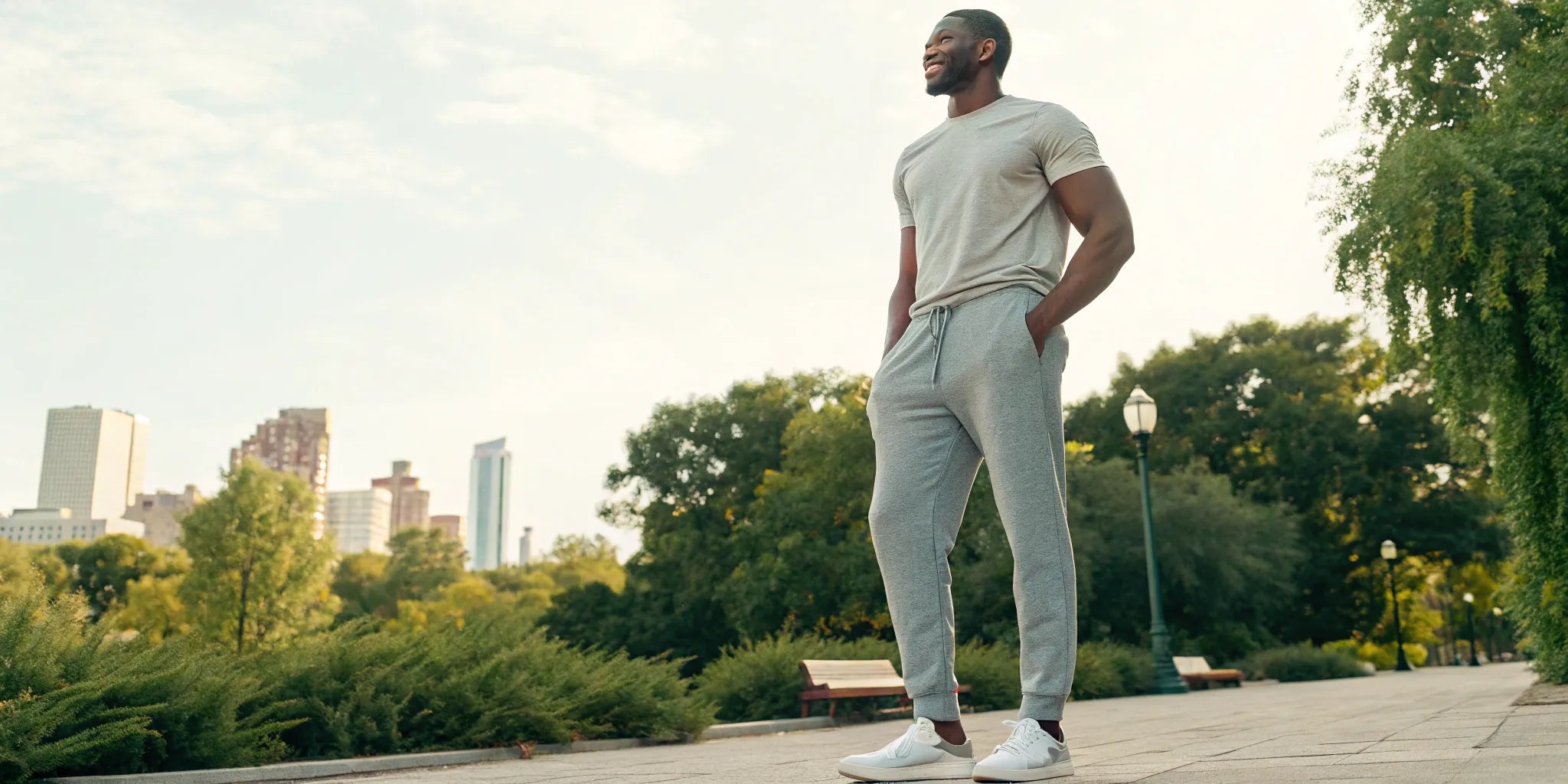 A tall man wearing a pair of well-fitting big and tall joggers outdoors.