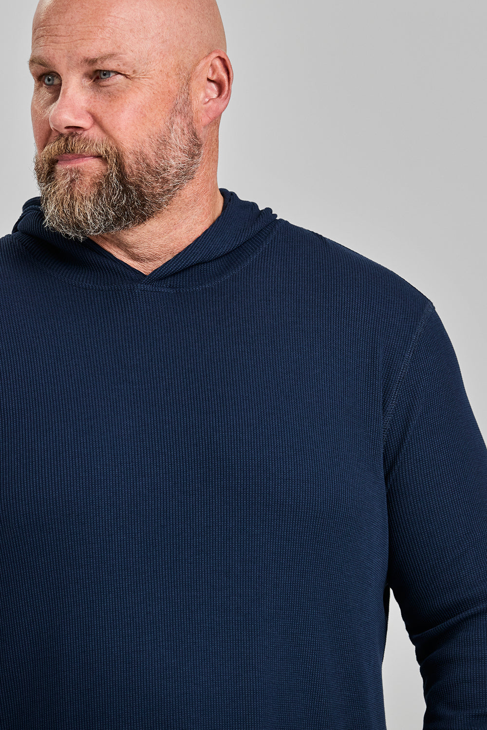 Side profile of big and tall man in navy WaffleFlex thermal hoodie